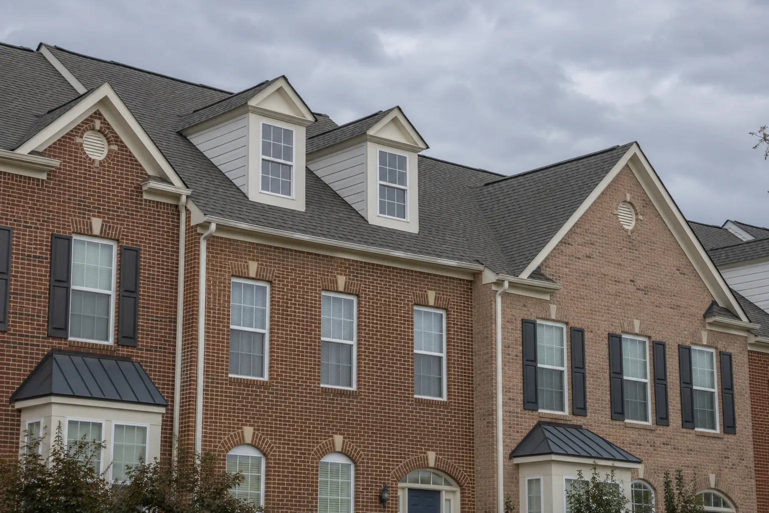 Chantilly and Centreville roofing guide illustration showing brick townhomes with connected asphalt shingle roofs