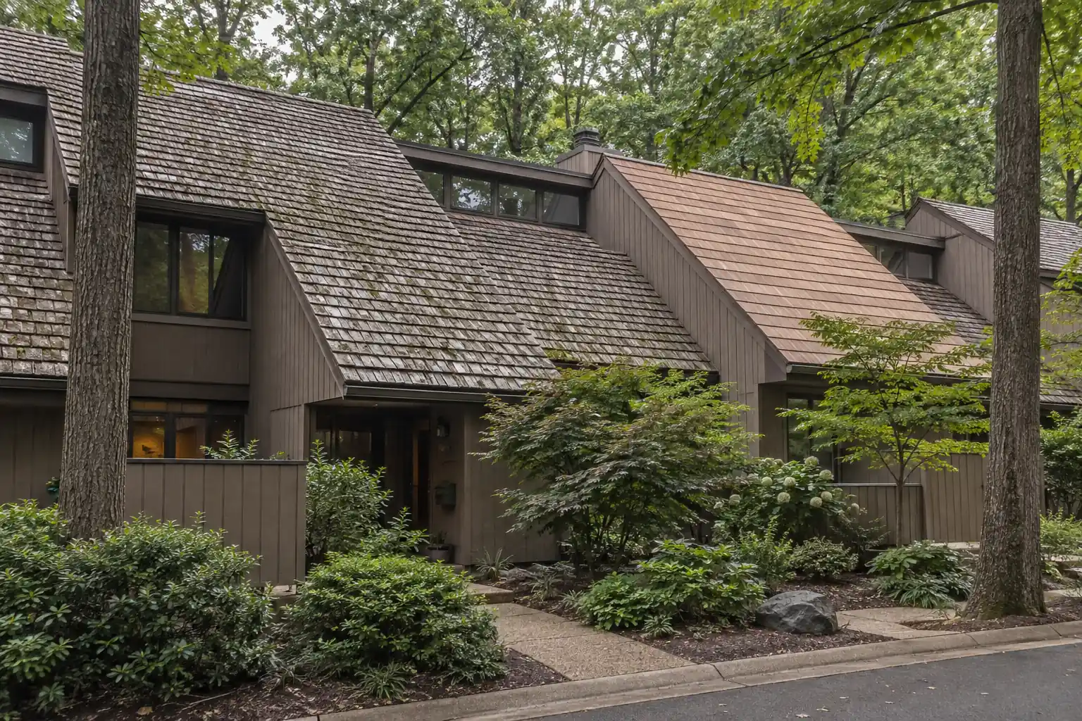 Wooded Reston Virginia cluster homes with aged cedar shake and a neighboring cedar-look composite roof section